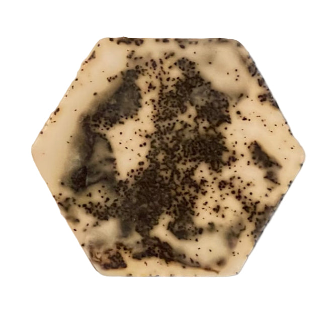 Hexagonal soap bar with a cream and dark speckled pattern on a white background