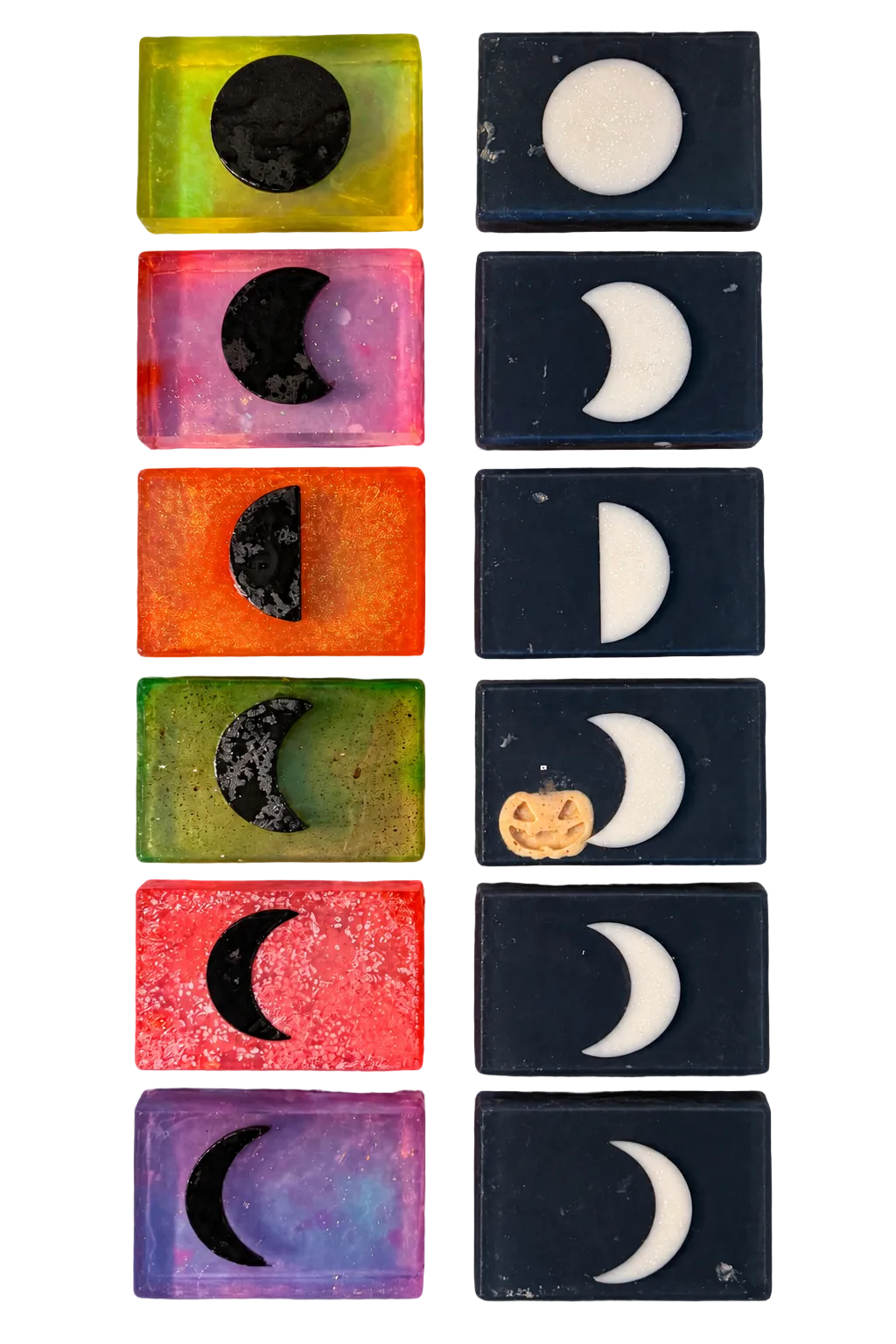 Twelve rectangular wax melts or soaps arranged in two columns of six. The left column shows various colorful wax melts with moon-phase designs (black, white, and gray crescents and full moons).