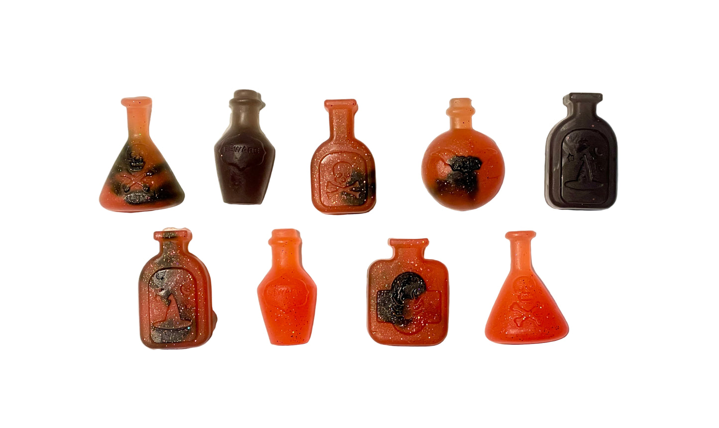 Set of small bottles with different designs on a white background